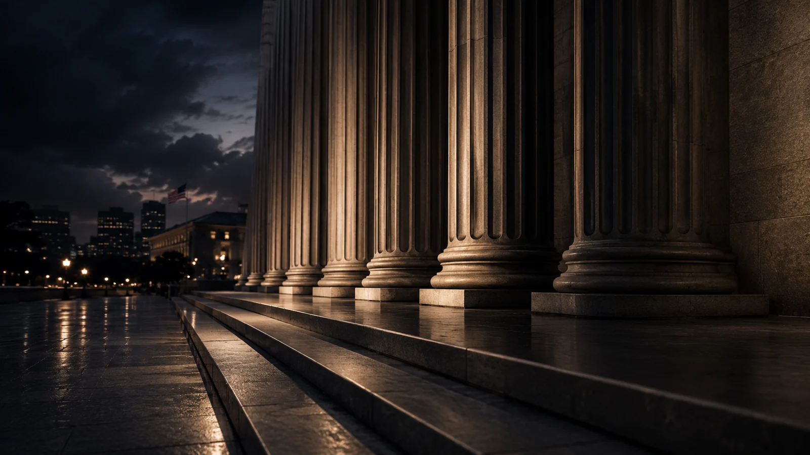 Courthouse columns and police lights at night